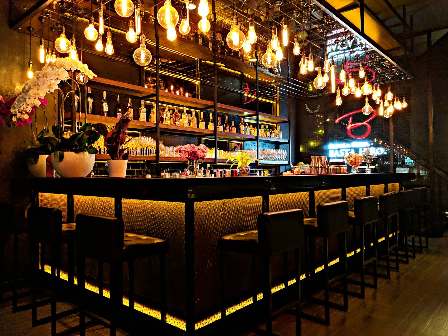A lit bar with stools on a quiet evening